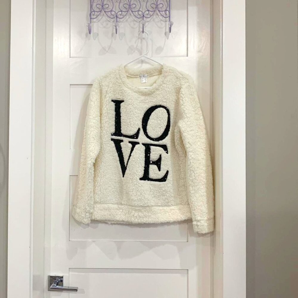 fluffy white sweater with "LOVE" design
